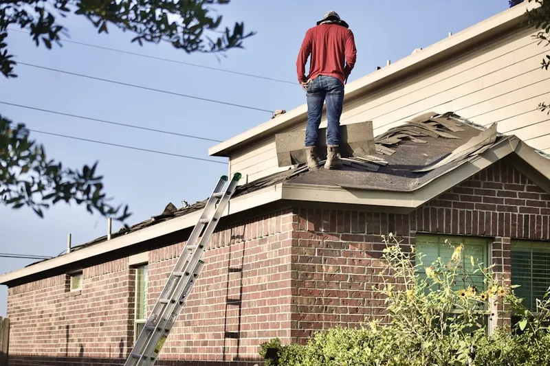Professional roofer working on a residential roof in Dreibelbis